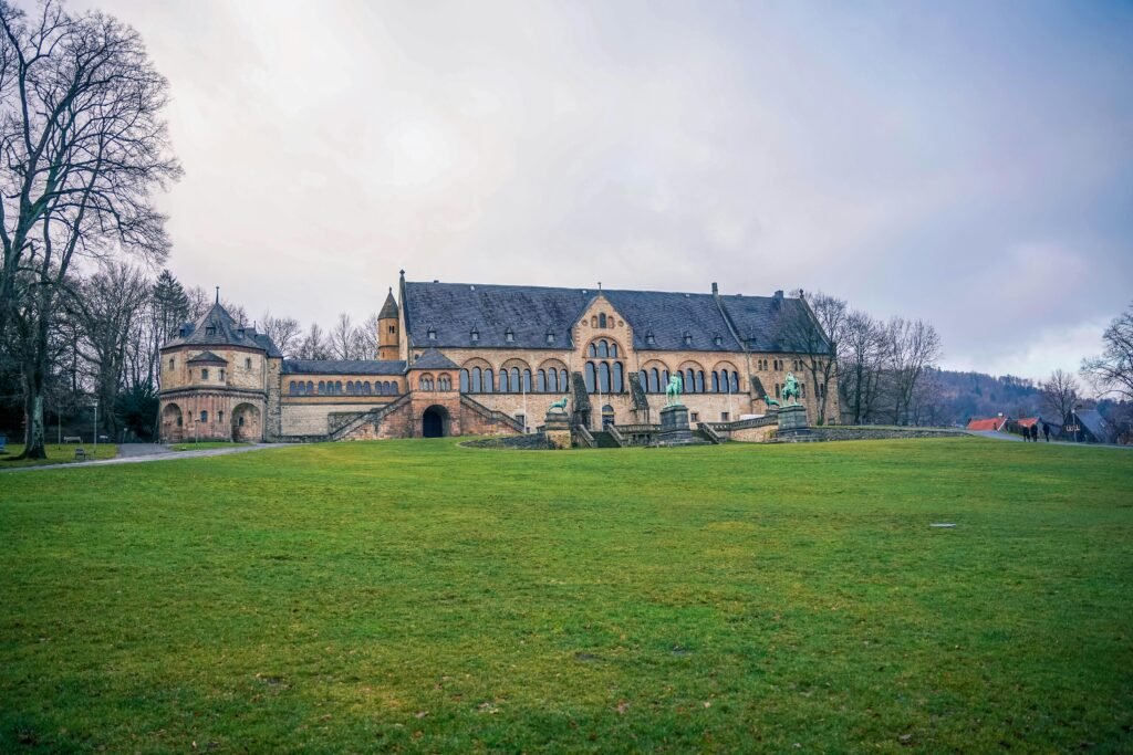 pexels-photo-15074208-15074208-1 Beautiful view of the Imperial Palace of Goslar, Germany, surrounded by lush greenery and winter sky.